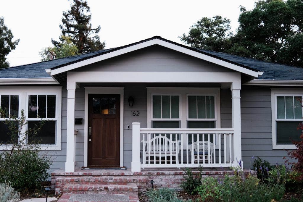 gray house with brick front porch