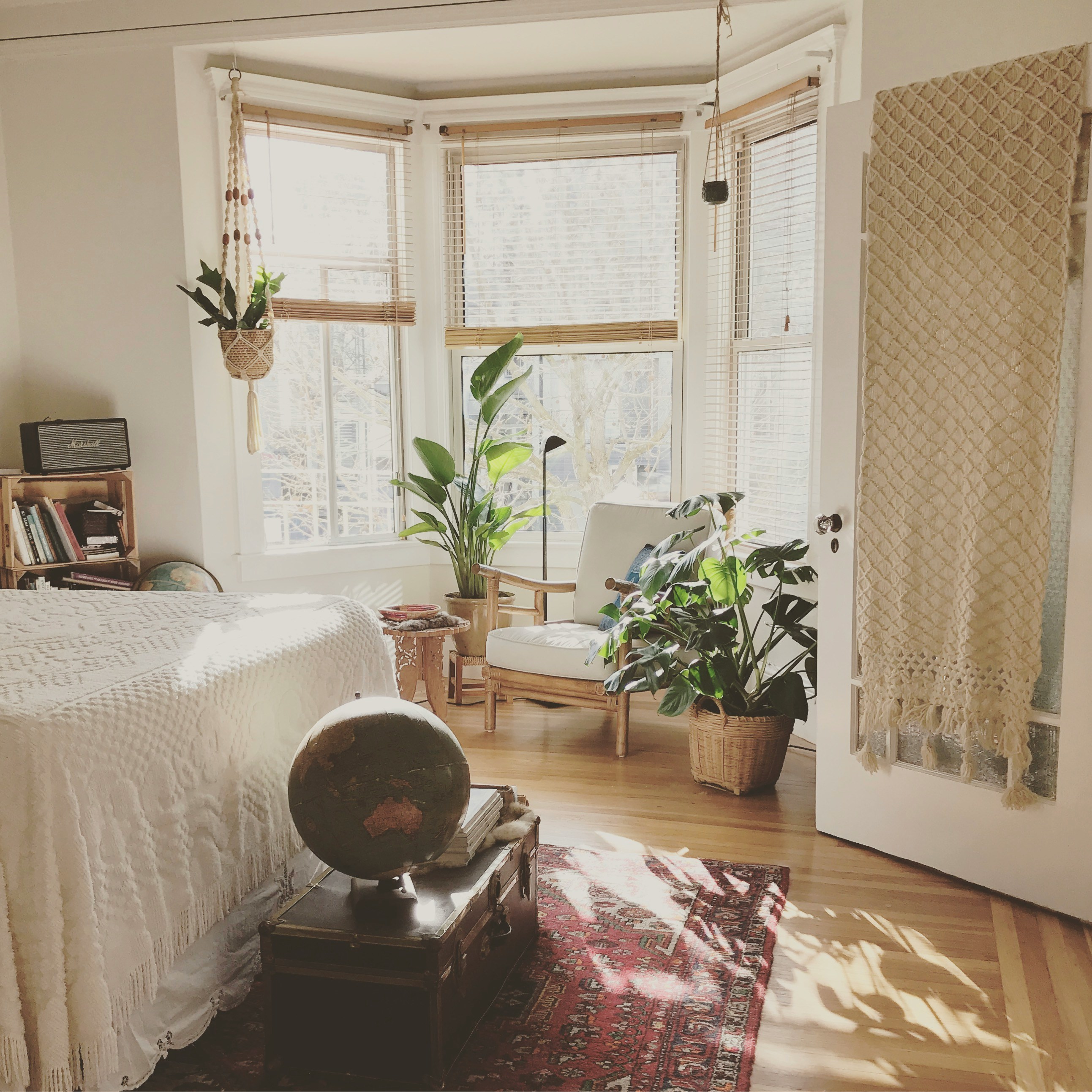 Sunny bedroom with plants in a bay window