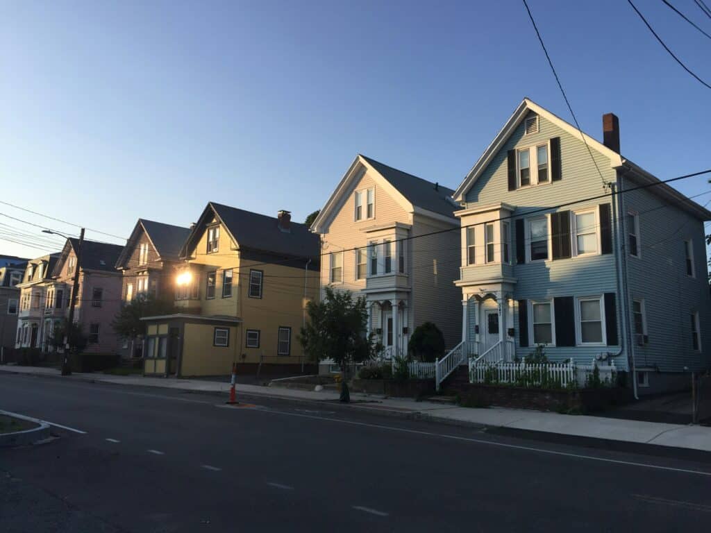 four multi-story homes in a row at sunrise