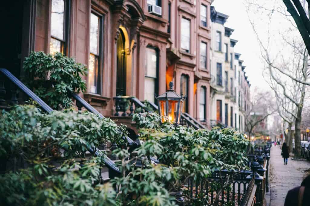 Brooklyn brownstones with lush greenery in foreground