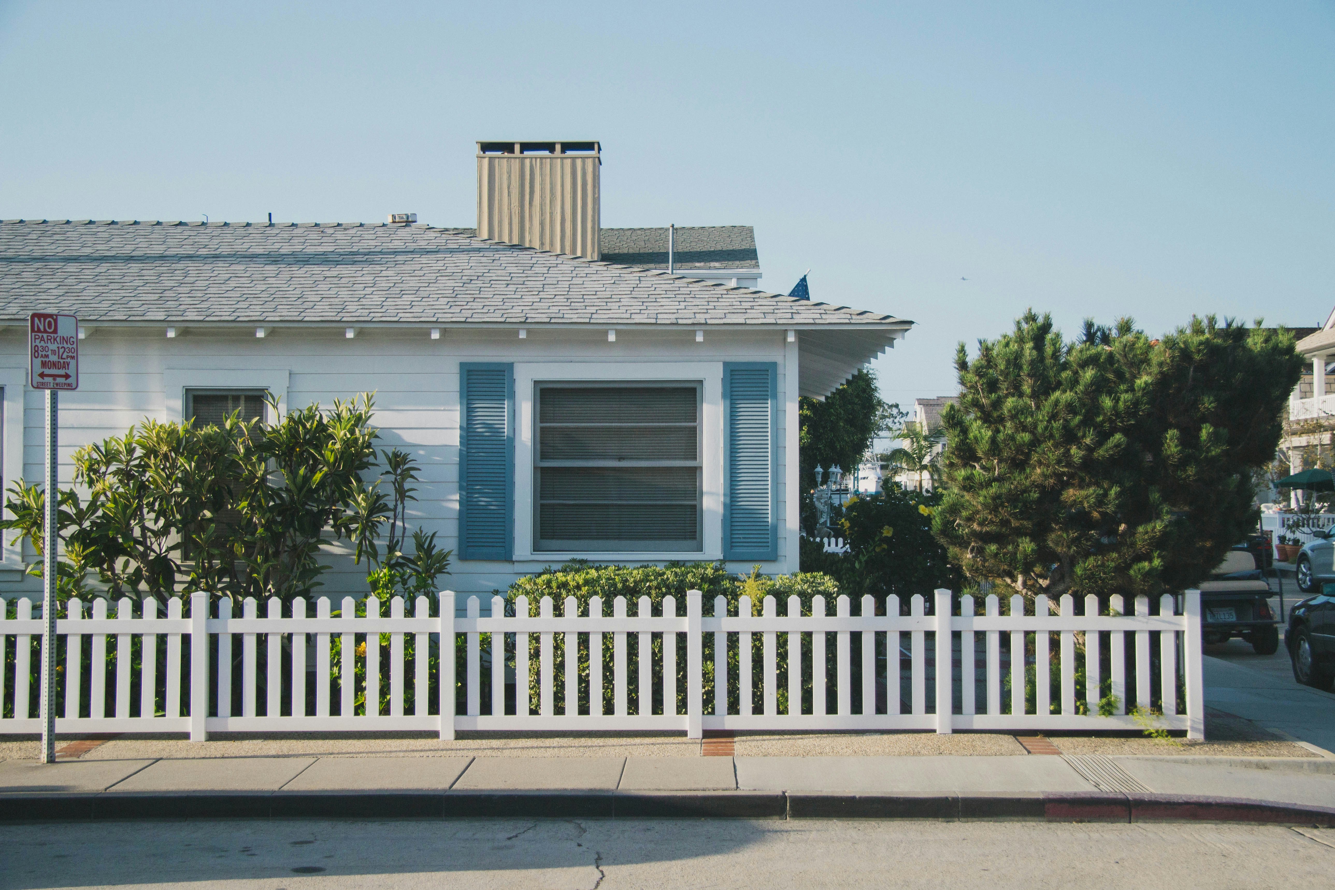 White house with blue shutters and white picket fence